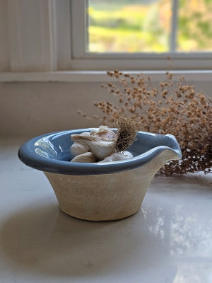 The Rustic Pour Bowl with Blue Glaze lends a vintage, old-world farmhouse look to any kitchen. It features a rustic hand-thrown pottery look with pour spout. The cottage blue glaze and unglazed bottom add to its rustic feel. 