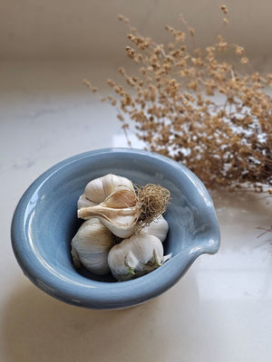The Rustic Pour Bowl with Blue Glaze lends a vintage, old-world farmhouse look to any kitchen. It features a rustic hand-thrown pottery look with pour spout. The cottage blue glaze and unglazed bottom add to its rustic feel. 