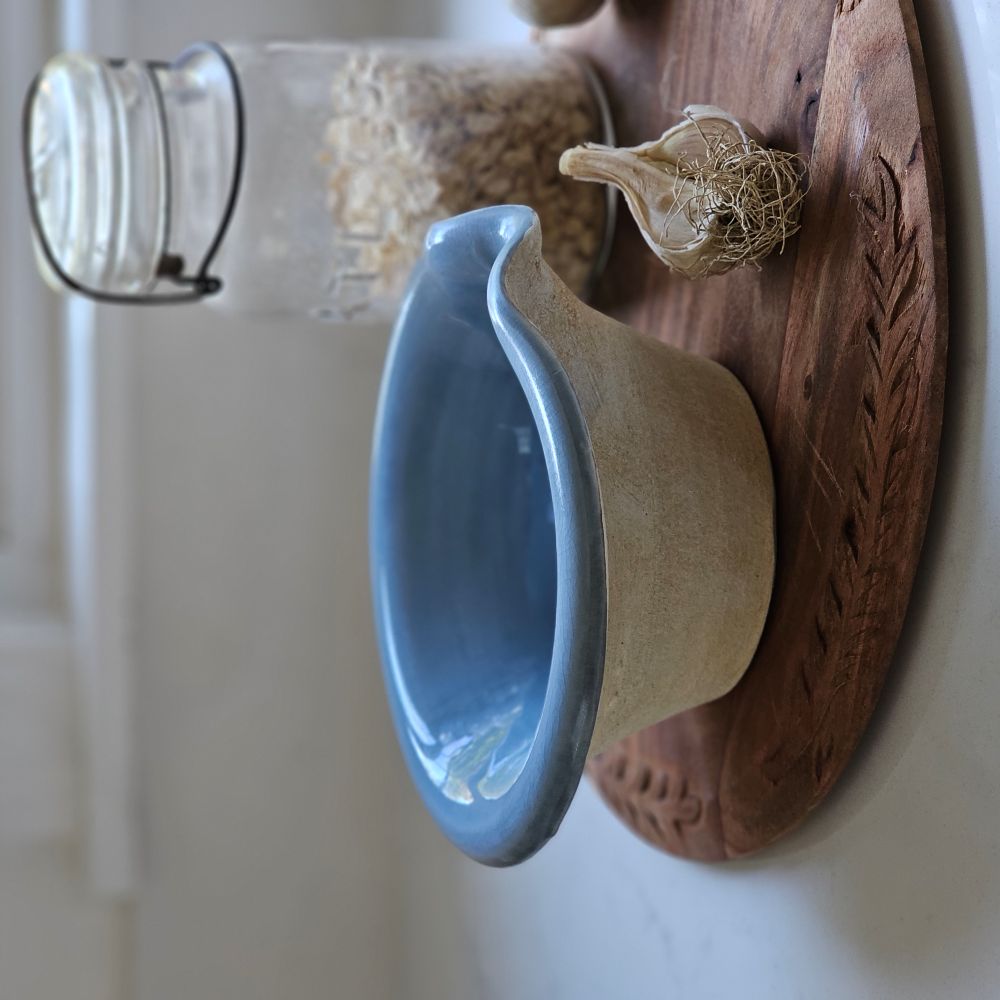 The Rustic Pour Bowl with Blue Glaze lends a vintage, old-world farmhouse look to any kitchen. It features a rustic hand-thrown pottery look with pour spout. The cottage blue glaze and unglazed bottom add to its rustic feel. 