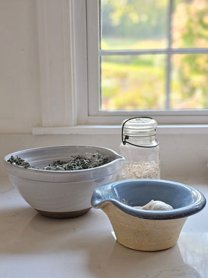 The Rustic Pour Bowl with Blue Glaze lends a vintage, old-world farmhouse look to any kitchen. It features a rustic hand-thrown pottery look with pour spout. The cottage blue glaze and unglazed bottom add to its rustic feel. 