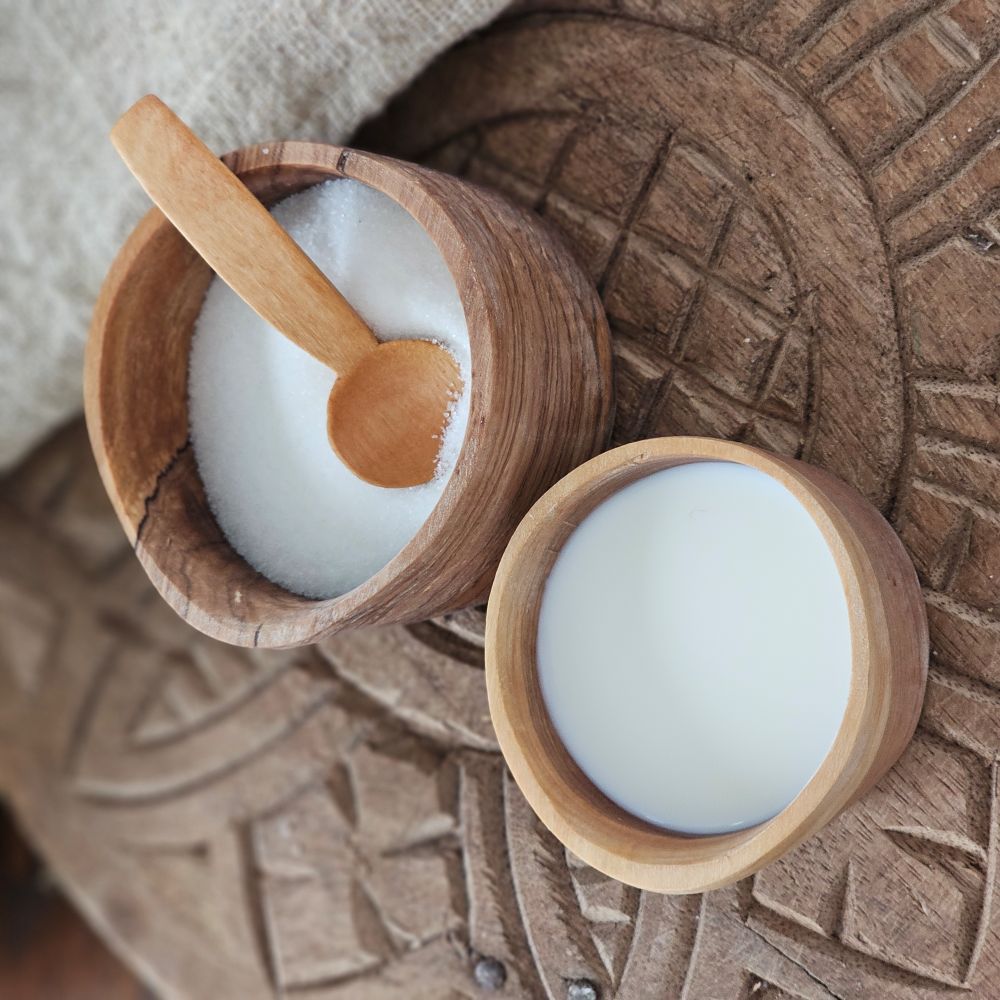 Simple utility at its finest, this hand carved wild olive wood cream and sugar serving set is crafted by talented artisans. The Rustic Olive Wood Sugar Bowl and Creamer Set includes a small sugar spoon, sugar dish and spouted creamer, all of which nest together nicely.