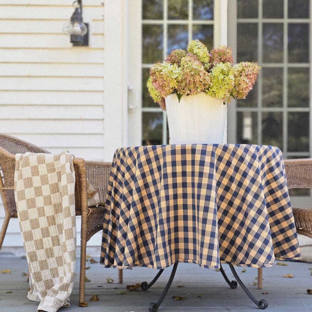 The Rustic Blue Check Tablecloth offers a versatile design choice for any farmhouse. The bold blue and rustic tan buffalo check design create a combination that works with so many decor styles. Whether it's French Country, English cottage or rustic farmhouse, this accent adds a charming touch.