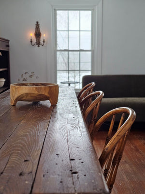 Add down-to-earth character to your farm table with our rustic Carved Wood Bowl with Legs. Inspired by the style of traditional hand-hewn dough bowls, this unique piece adds a touch of imperfection and charm. The decorative bowl is crafted from thick, carved wood and can be displayed year-round on a table, shelf, or counter. Each bowl is truly one-of-a-kind and complements any relaxed, rustic decor. 