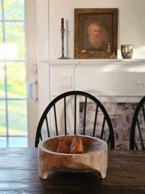 Add down-to-earth character to your farm table with our rustic Carved Wood Bowl with Legs. Inspired by the style of traditional hand-hewn dough bowls, this unique piece adds a touch of imperfection and charm. 