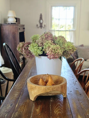 Add down-to-earth character to your farm table with our rustic Carved Wood Bowl with Legs. Inspired by the style of traditional hand-hewn dough bowls, this unique piece adds a touch of imperfection and charm.