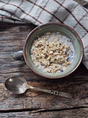 Embrace warmth and comfort with the Rustic Ceramic Soup Mug. Handcrafted with care, this earthy ceramic mug is designed to warm your hands while holding your favorite soups, stews, oatmeal, or hot beverages. Finished with a reactive blue/green/gray glaze, each piece features unique variations in color and speckling, adding an organic and artisanal touch to your tableware collection.