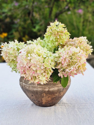 Add down-to-earth elegance to any room with our Rustic Distressed Clay Pot Vase. The washed brow finish lends a textured look, giving this piece an old-world, organic touch. The watertight finish allows you to display your favorite fresh floral arrangements to create stunning farm table centerpieces.