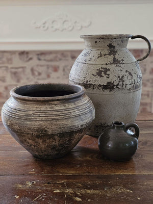 Bring old world charm to your farmhouse with this old style Rusty Milk Jug. This antique inspired reproduction features a highly distressed metal finish in a grey tan color with a rusty aged look . Perfect for bringing a bit of vintage flair to your farmhouse.