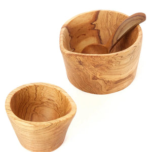 Simple utility at its finest, this hand carved wild olive wood cream and sugar serving set is crafted by talented artisans. The Rustic Olive Wood Sugar Bowl and Creamer Set includes a small sugar spoon, sugar dish and spouted creamer, all of which nest together nicely.