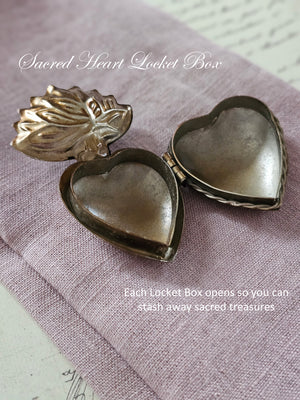 Introducing the Sacred Heart Locket Box, the perfect blend of vintage style and old-world charm. Crafted from aged metal with a golden bronze finish and intricate etchings, this locket box offers a timeless storage solution for your sacred treasures. Hang it from a chain or ribbon with the attached loop (Ribbon not included). A must-have for any collector.