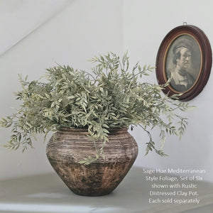 Add down-to-earth elegance to any room with our Rustic Distressed Clay Pot Vase. The washed brow finish lends a textured look, giving this piece an old-world, organic touch. The watertight finish allows you to display your favorite fresh floral arrangements to create stunning farm table centerpieces. 9" diam x 6.5"H