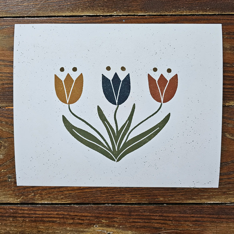 The simplicity and boldness of this Scandinavian Style Tulip Art Print lends instant charm to any room. Features three tulips in rustic shades of mustard, navy and burnt orange. Professionally printed on high quality archival fine art paper that has a oatmeal grain flecks with archival inks. Listing is for the art print only, frame not included. 10 x 8 Made in the USA