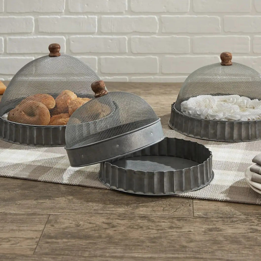 Keep bugs at bay on warm summer days with our Screen Food Covers with Metal Base, Set of Three . A wire mesh cloche, also known as a shoo-fly, is perfect for protecting food from flies and other insects.  Our set of three Wire Mesh Food Covers has tons of vintage charm and offers a range of sizes. They feature aged metal base with scalloped edges. Add rustic elegance to your farmhouse kitchen or patio with our vintage style Screen Food Covers, Set of Three. 8.75" DIA X 5.5"H 10.75" DIA X 8"H 12" DIA X 9"H