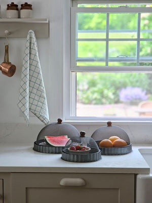 Keep bugs at bay on warm summer days with our Screen Food Covers with Metal Base, Set of Three . A wire mesh cloche, also known as a shoo-fly, is perfect for protecting food from flies and other insects. Our set of three Wire Mesh Food Covers has tons of vintage charm and offers a range of sizes. They feature aged metal base with scalloped edges. Add rustic elegance to your farmhouse kitchen or patio with our vintage style Screen Food Cover Cloches