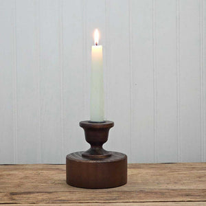 Bring a touch of timeless charm to your space with the Scribner Taper Candlestick Holder. Crafted from solid wood and finished in a rich, dark chestnut hue, this piece channels the cozy spirit of early American farmhouses. Its simple, sturdy design makes it perfect for brightening up your mantle, desktop, or dresser with a warm, rustic glow.