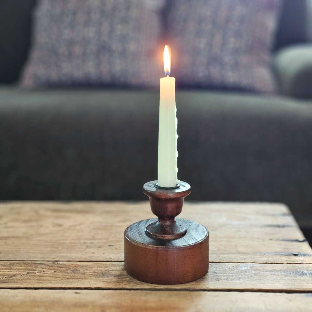 Bring a touch of timeless charm to your space with the Scribner Taper Candlestick Holder. Crafted from solid wood and finished in a rich, dark chestnut hue, this piece channels the cozy spirit of early American farmhouses. Its simple, sturdy design makes it perfect for brightening up your mantle, desktop, or dresser with a warm, rustic glow.