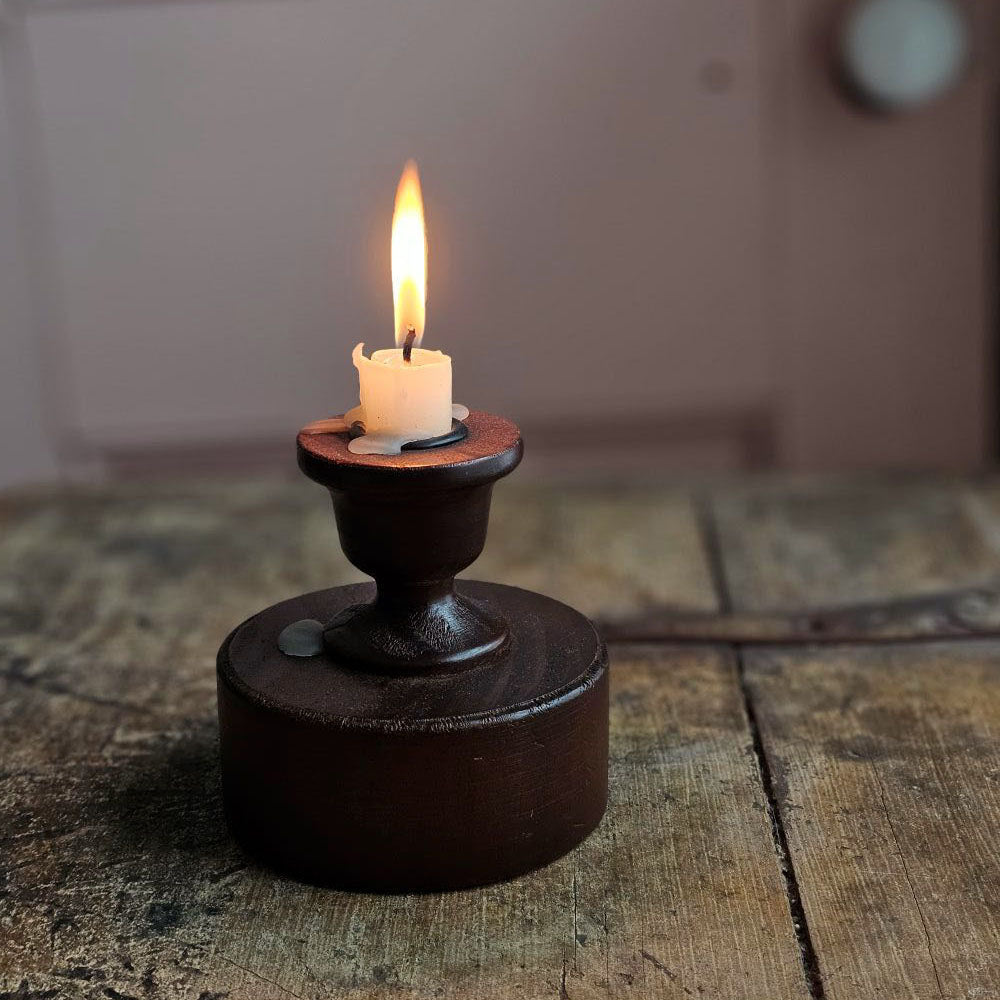 Bring a touch of timeless charm to your space with the Scribner Taper Candlestick Holder. Crafted from solid wood and finished in a rich, dark chestnut hue, this piece channels the cozy spirit of early American farmhouses. Its simple, sturdy design makes it perfect for brightening up your mantle, desktop, or dresser with a warm, rustic glow. Whether you're setting the mood for a quiet evening or adding character to your decor, this candlestick holder is a delightful nod to the past with a playful twist.