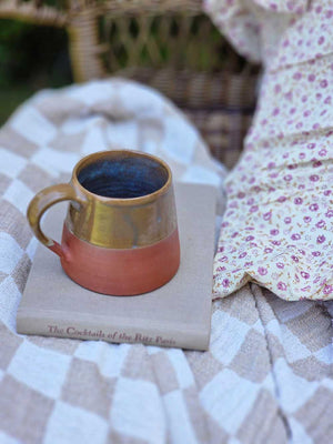 The Sedona Rustic Glazed Mug combines artisanal craftsmanship with natural beauty, showcasing a harmonious blend of terracotta clay and a uniquely imperfect glaze. Its earthy exterior and subtle moody blue interior evoke a refined yet grounded ambiance, making every coffee moment feel thoughtfully curated and effortlessly cozy.