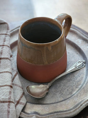 The Sedona Rustic Glazed Mug combines artisanal craftsmanship with natural beauty, showcasing a harmonious blend of terracotta clay and a uniquely imperfect glaze. Its earthy exterior and subtle moody blue interior evoke a refined yet grounded ambiance, making every coffee moment feel thoughtfully curated and effortlessly cozy.