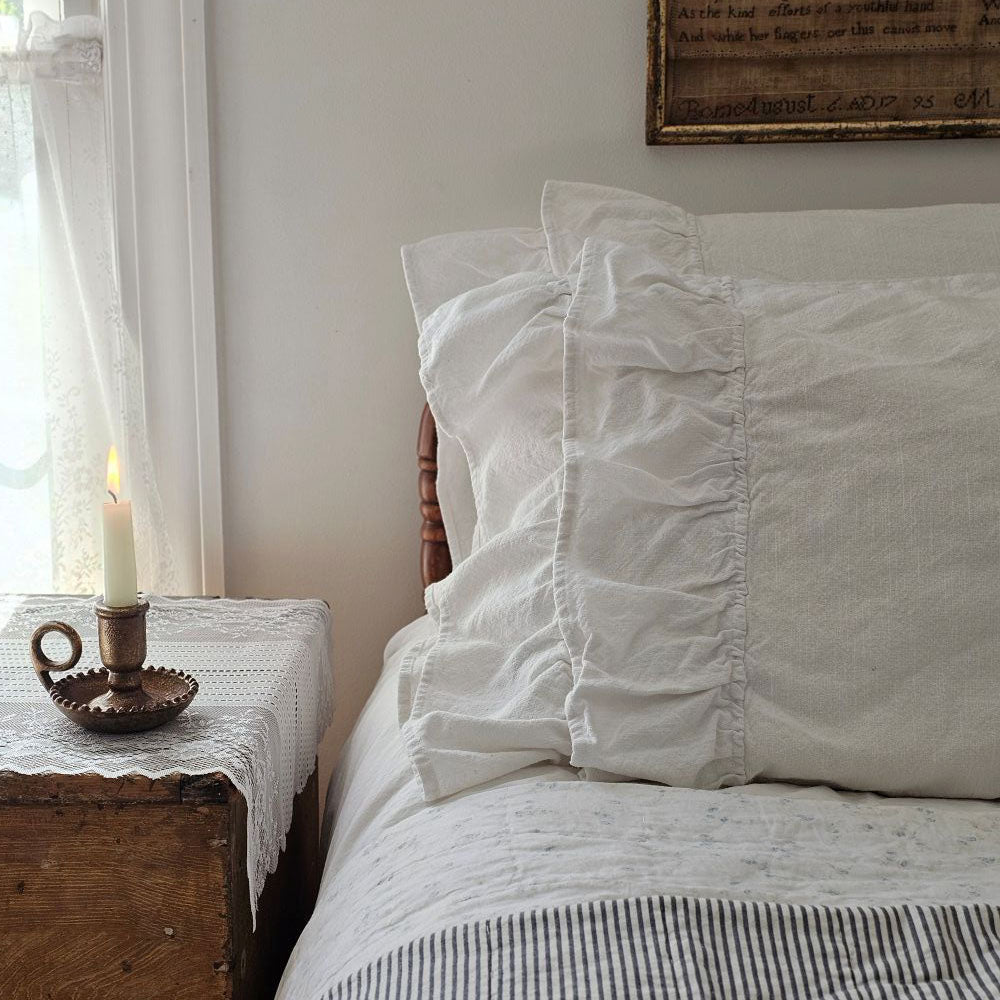 Our Serenity White Lush Ruffle Pillowcase Set brings dreamy cottage style to any bedroom. This ultra soft pillowcase set features two lavish rows of ruffles accenting the open edge of the pillowcases. Each ruffle measures 5" long with the top ruffle slightly overlapping the other. These 100% cotton pillowcases feature a weave with a substantial-weight that lends a vintage, old-world linen look and is both durable and surprisingly soft to the touch.