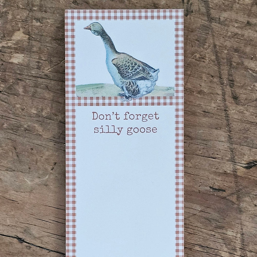 The Silly Goose Notepad features vintage art of a goose with an golden yellow gingham border around a blank writing space and a little reminder that reads "Don't Forget Silly Goose." The Silly Goose list pad includes 60 pages and a strong magnet to easily hang on magnetic surface for display. Made in the USA. 2.5"W x 9.5"H