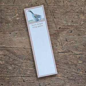 The Silly Goose Notepad features vintage art of a goose with an golden yellow gingham border around a blank writing space and a little reminder that reads "Don't Forget Silly Goose." The Silly Goose list pad includes 60 pages and a strong magnet to easily hang on magnetic surface for display. Made in the USA. 2.5"W x 9.5"H