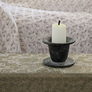 Enhance your home decor with our Simple Distressed Taper Candle Holder. Featuring a primitive and minimalist design, this black metal holder boasts a distressed finish that adds hints of grey and rust, creating a rustic ambiance. Perfect for adding a quiet simplicity to any room. Taper candle not included.