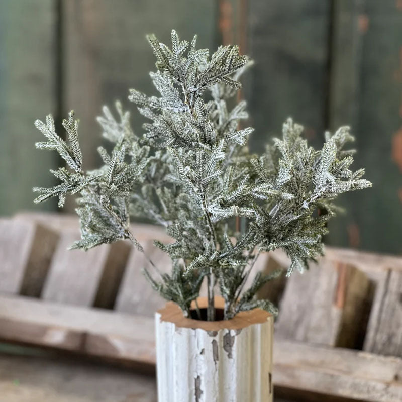 A touch of sparkle gives this Snow Dusted Pine Bush a magical, wintry feel. Each bush has realistic pine branches with frosty coating of faux snow completed with a subtle touch of glitter. This gently flocked bough looks charming alone or tucked into a winter bouquet. 