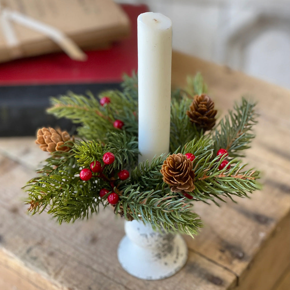 Add festive cheer to your taper candle with our Spruce and Berries Taper Candle Ring. This accent features a fresh collection of faux spruce peppered with sprigs of red berries and dashed with petite pine cones.Perfect for adding an earthy twist to taper candle holders and chandeliers, this ring provides a charming decorative accent all year long. Includes one ring. Candles and candle holders not included. 7” Diam with 2”inner