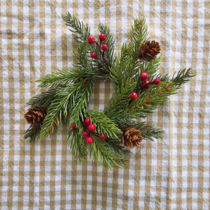 Add festive cheer to your taper candle with our Spruce and Berries Taper Candle Ring. This accent features a fresh collection of faux spruce peppered with sprigs of red berries and dashed with petite pine cones.Perfect for adding an earthy twist to taper candle holders and chandeliers, this ring provides a charming decorative accent all year long. Includes one ring. Candles and candle holders not included. 7” Diam with 2”inner