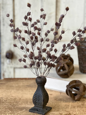 The Winter Spur Seed Bush adds a rustic, down-to-earth charm to any room. Branching stems are peppered with small spurs that resemble tiny pine cones. A nice variation of brown and plum tones topped with a slight white wash gives them a unique and magical woodland appearance. 