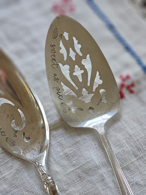 So sweet! So vintage! Darling pie servers are hand-stamped "Sweet as Pie". Made from vintage silver plate servers, each item will be unique. Due to their vintage nature, flatware pieces may show signs of age and gentle use. No two are alike and the handle will vary. The pie servers are all lovingly collected by the artist from flea markets and antique shops and then hand-stamped with care. Includes one pie server. Each approximately 8.25"L. Made in the USA. 
