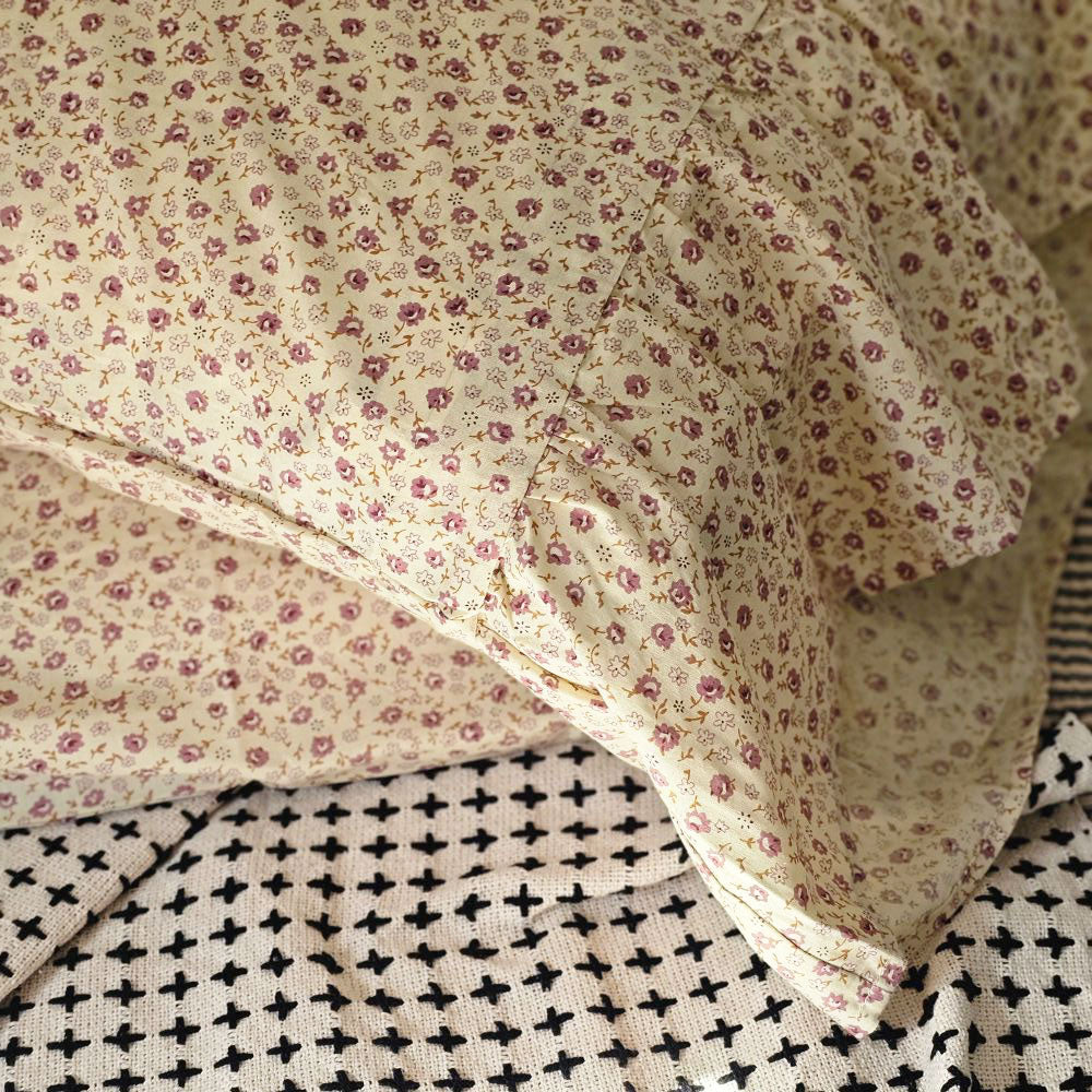 Add beautiful texture and vintage style to your bedroom with the Sweet Prairie Pillowcase Set. This cotton pillow slip set includes a delightful vintage floral pattern in soft creamy yellow with small mauve flowers and moss green details. The set features double-sewn seams for extra durability as well as extra length to ensure good coverage of your fill pillow (not included). An generous 8-inch ruffle lends country cottage elegance. The 100% cotton weave features a crisp, vintage feel.