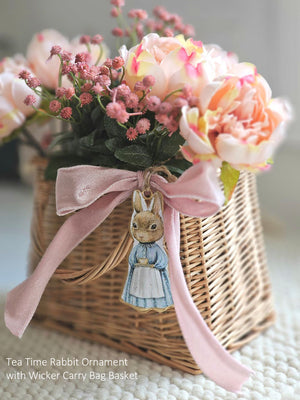 Inspired by Peter Rabbit's mom, this Tea Time Rabbit Ornament lends fairy tale cottage charm to any room. Wearing a classic cottage apron, this bunny is ready for a tea time break. Hang from a hook or from a basket full of your favorite flowers. Image featured on each side of the ornament