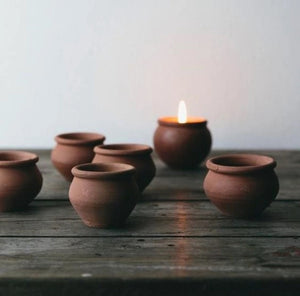 Add rustic ambiance with our Terracotta Candle Pots, Set of Four. Hand-crafted terracotta pots are filled with a blended beeswax and scented with lavender and a hint of vanilla. Set of four. Fair trade. Makes a great gift!