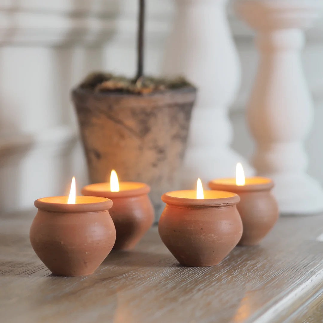 Add rustic ambiance with our Terracotta Candle Pots, Set of Four. Hand-crafted terracotta pots are filled with a blended beeswax and scented with lavender and a hint of vanilla. Set of four. Fair trade. Makes a great gift!