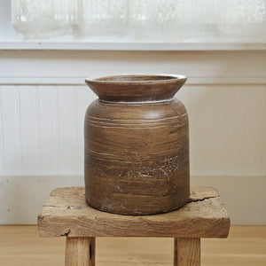 Add down-to-earth elegance to any room with our Rustic Terracotta Pot Vase. Finished to look like weathered wood, its textured look and natural wood hue bring an organic touch to your home decor. The watertight finish allows you to display your favorite fresh floral arrangements to create stunning farm table centerpieces. 7" diam x 8.9"H
