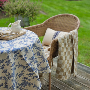 Our Toile Fabric-Blue Flowers adds instant French Country cottage charm. Features a rich blue floral toile design on a rustic oatmeal background. This fabric can be used to make pillows and more, but we love it simply as a no-sew tablecloth (doesn't have a stitched hem) for casual country style. Layer with other tablecloths to create a cozy farmhouse feel. Perfect for café tables or small square table that seat 2-4. 100% Cotton. Hand wash. Line dry. 59” x 59”   