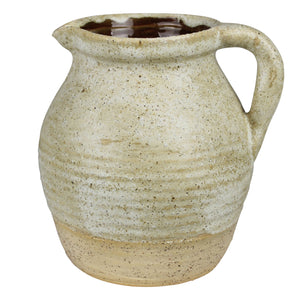 Our Tudor Farm Kitchen Pitcher embodies an old farmhouse aesthetic and Wabi Sabi philosophy—celebrating imperfection, simplicity, impermanence, nature, and uniqueness. Perfect for adding artisanal elegance to any setting. Features a rustic oatmeal color glaze with a natural, non-glazed bottom for an antique and timeless look. Decorative use only. 