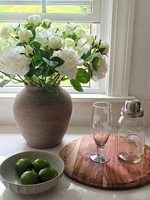 White Allium mixed with White Roses and Etched Glass Flute on Bread Board