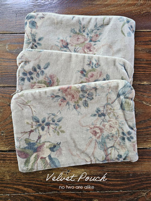 The Velvet Pouch with Vintage Floral Design is an elegant clutch perfect for makeup and other essentials. It showcases a romantic velvet floral pattern on one side, complemented by a smooth light beige-pink satin backside. Measuring 9" wide by 6" high, this zippered pouch combines style with practicality. Print will vary on each bag.