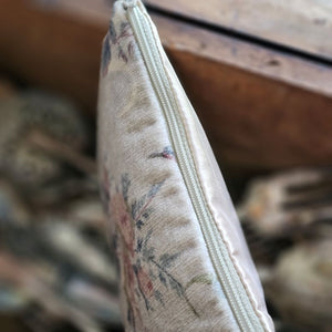 The Velvet Pouch with Vintage Floral Design is an elegant clutch perfect for makeup and other essentials. It showcases a romantic velvet floral pattern on one side, complemented by a smooth light beige-pink satin backside. Measuring 9" wide by 6" high, this zippered pouch combines style with practicality. Print will vary on each bag.