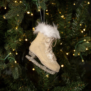 This Velvet Ice Skate Ornament brings a festive touch to any holiday decor. Its old-timey design features a silver sparkle skate, creamy-beige fur, and a fluffy white fur collar. Show off your winter wonderland style with this unique ornament for your tree, wreaths, or use as a gift-topper. 4.25"L