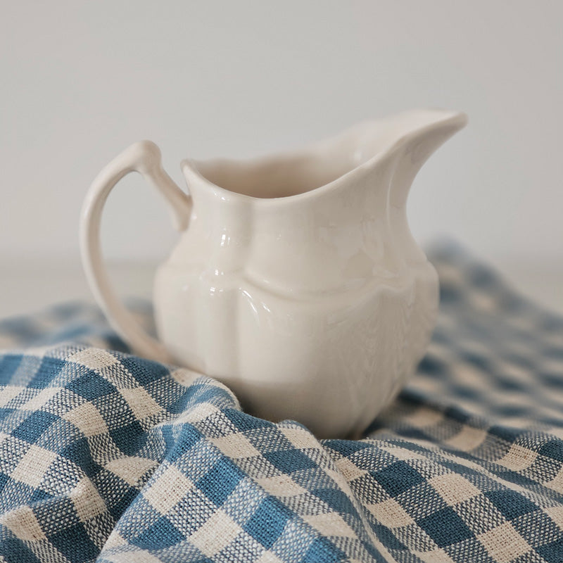 https://farmhousewares.com/cdn/shop/files/Vintage-Style-Stoneware-Creamer-with-Cottage-Blue-Gingham-Towel-SQ_800x.jpg?v=1702583448