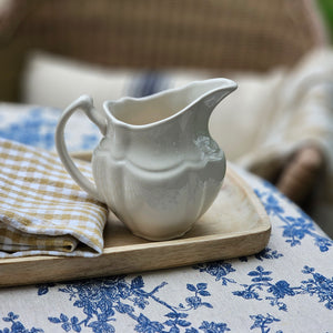 Reminiscent of old ironstone pitchers that would be used along with basins, our Vintage Style Stoneware Creamer has a graceful design. Makes a beautiful accent to any sideboard or shelf. It's off white glaze gives it an antique look.  5.25" l x 4" w x 5" h