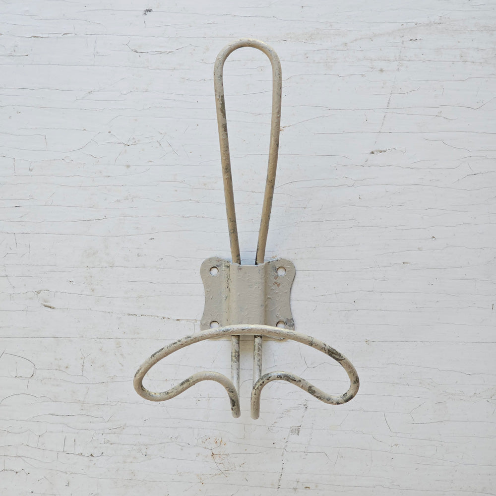 Reminiscent of vintage wire hooks found in old schoolhouse coat rooms or farmhouse bedrooms, this charming Vintage Style Wire Coat Hook in Mushroom is perfect for farmhouse living. Whether your style is country farmhouse or vintage industrial, these old-fashioned wire hooks have a simple design that will be at home in any mudroom, kitchen or bedroom.  The distressed wire hook has an off-white chippy paint finish in a light grey/tan mushroom tones 