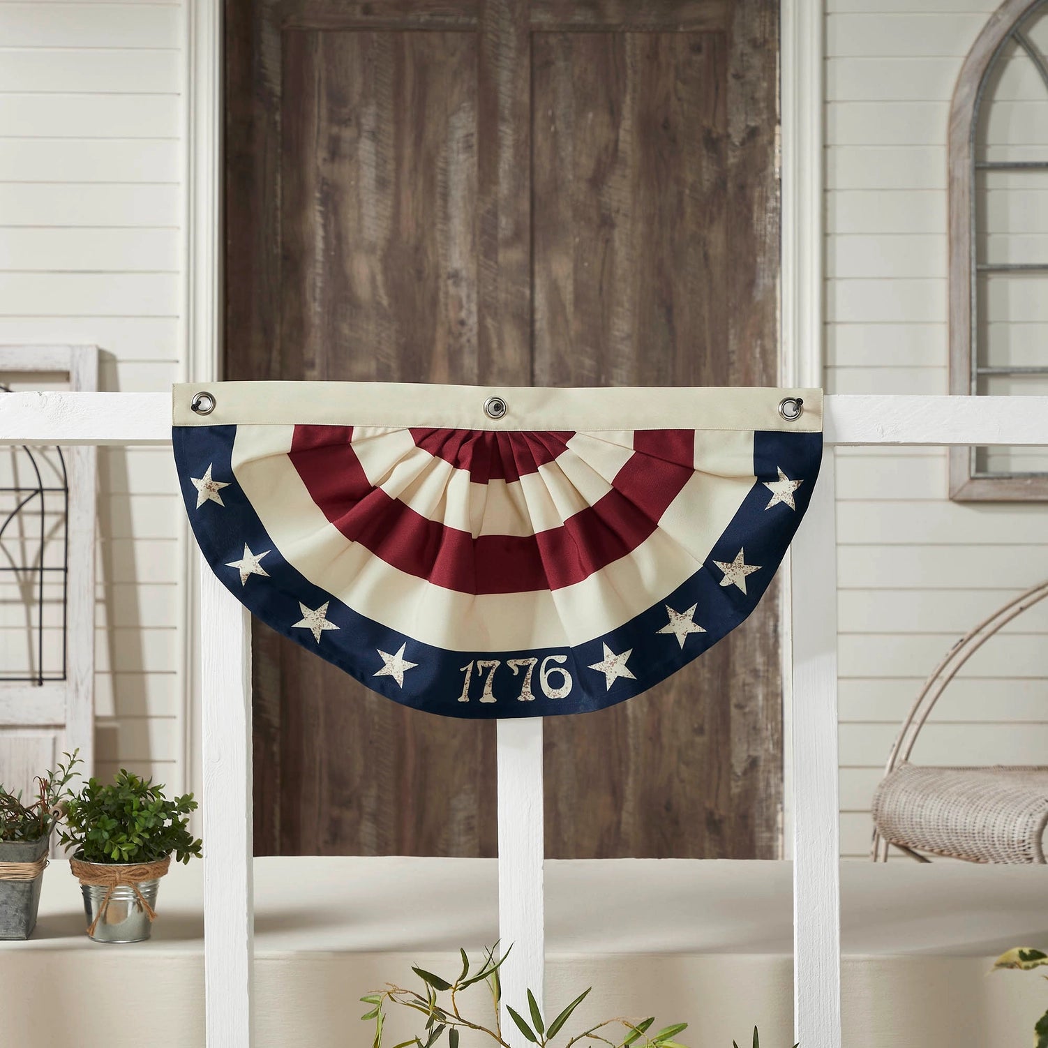 Add vintage charm style to windows and porch banisters with this Vintage Americana Bunting Flag. This classic half-circle bunting flag features deep pleats in alternating red and cream stripes, creating a timeless and elegant look. The navy blue stripe at the top is adorned with cream stars and the iconic "1776," honoring the birth of American independence. Equipped with durable grommet holes, this banner is easy to hang, making it perfect for a variety of decorative uses. 