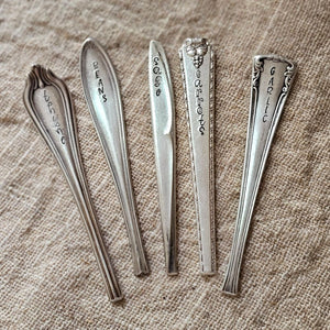 So sweet! So vintage! These darling Vintage Serveware Stem Herb Markers come as a set of five in various shapes, sizes and plant variety. No two sets are alike!&nbsp; Found at flea markets and antique shops, these vintage markers are hand-etched and offer unique charm. Due to their vintage nature, flatware pieces may show signs of age and gentle use. No two are alike and the handles and plant variety will vary with each set.Hand wash recommend. Set of five. Each approximately 3.5-5"H. Found in the US
