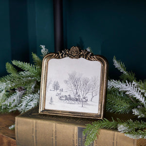 The Vintage Sleigh Ride Framed Wall Art adds a touch of old-world charm to any living space. The oval-top frame offers a unique touch. It features a molded ornate design with metallic antique golden wash over black for a antique look. This winter scene will bring a cozy, nostalgic feel into your home. Frame is plastic with no glass, making it light and easy to hang.