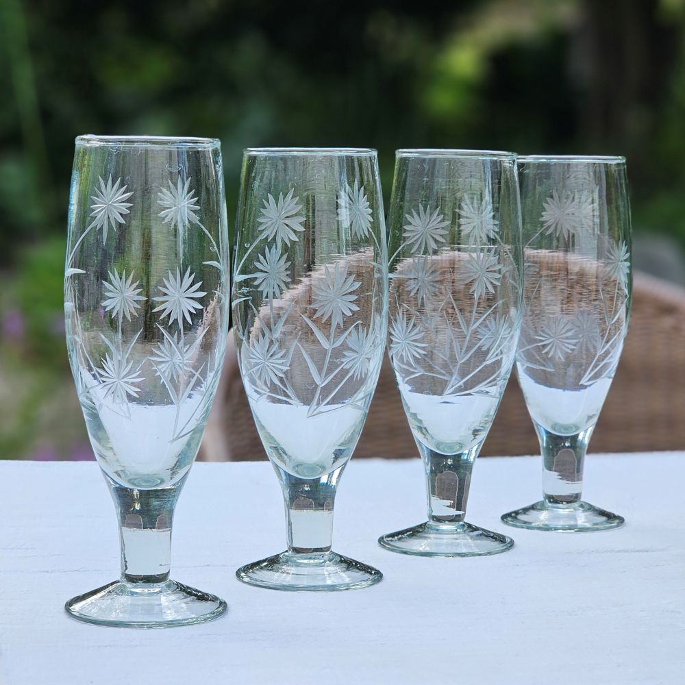 Inspired by antique shop finds, the Vintage Style Etched Flute Glasses, Set of Four brings timeless elegance to any occasion. The etched flower design lends a sophisticated vintage aesthetic that adds character and charm to any table setting. Ideal for farmhouse kitchens, cottage-style entertaining, or as a meaningful gift for those who appreciate quality glassware